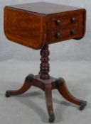 A Regency mahogany, satinwood crossbanded and ebony strung drop flap work table with frieze