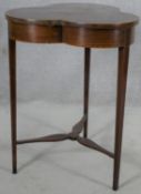 An Edwardian mahogany and satinwood inlaid occasional table with trefoil shaped top raised on square