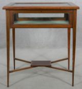 An Edwardian mahogany, satinwood crossbanded and ebony strung vitrine on square tapering supports