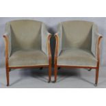 A pair of Edwardian mahogany and satinwood inlaid upholstered tub armchairs on square tapering