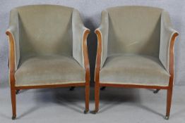A pair of Edwardian mahogany and satinwood inlaid upholstered tub armchairs on square tapering