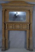 A large 19th century pitch pine fire surround and overmantel with architectural pediment above