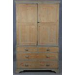 A 19th century pine press cupboard fitted with linen slides above two short and two long drawers