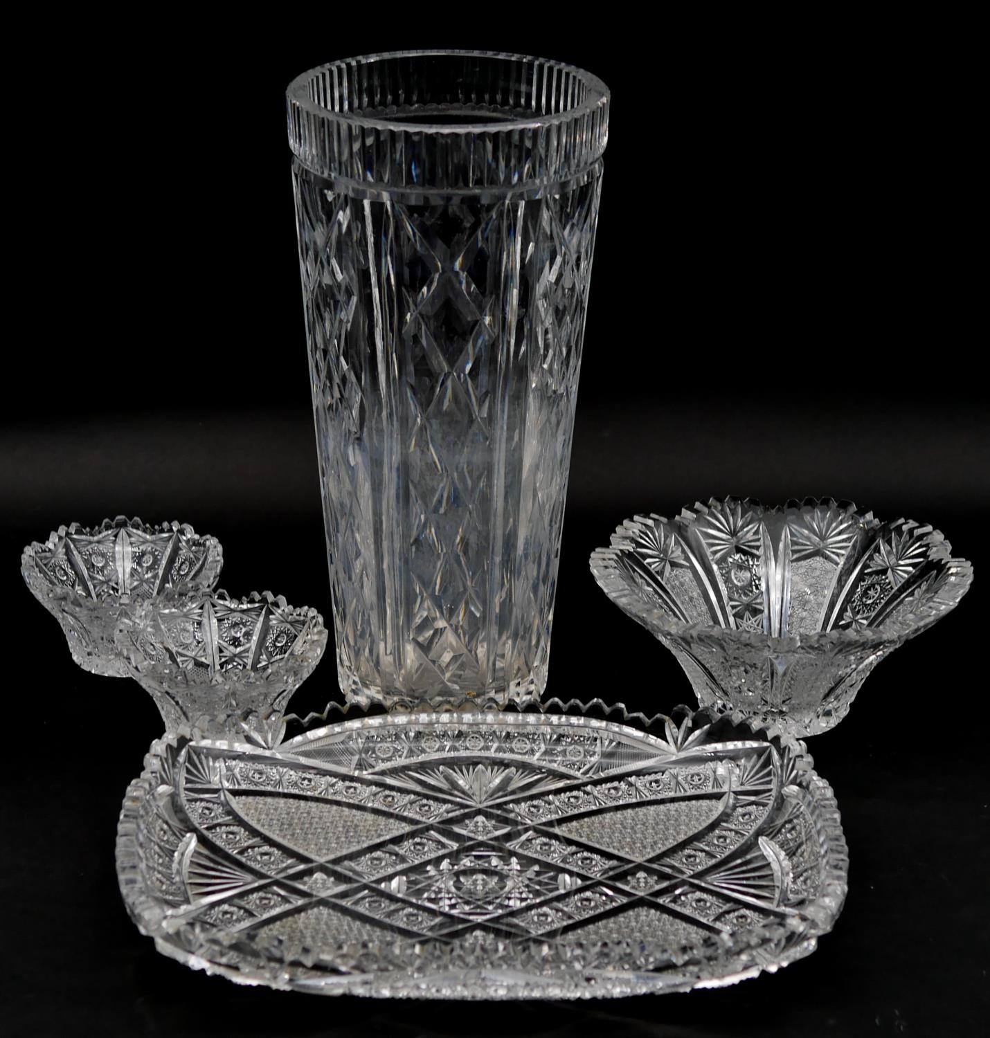 A collection of cut crystal and glass items. Including a large cut crystal vase with geometric