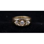 A Victorian 18 carat yellow gold and diamond three stone gypsy ring. Set to centre with a cushion