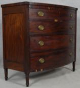 A 19th century mahogany bowfronted chest of four long drawers flanked by reeded pilasters on