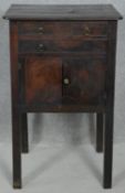 A Georgian mahogany night table fitted with dummy drawers and twin carrying handles on square