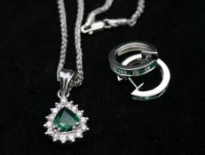 An 18 carat white gold emerald and diamond pendant and chain with emerald and diamond hoop earrings.