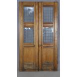 A pair of late 19th century pitch pine exterior doors with leaded windows, taken from the Welsh
