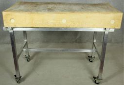 A butchers block on metal trolley base with wheel casters each fitted with a foot brake. H.95 W.