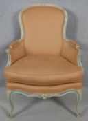 A Louis XV style carved and painted frame fauteuil in piped damask upholstery on cabriole