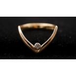 A 9ct yellow gold and diamond wishbone ring, set with a round brilliant cut diamond in a rubover