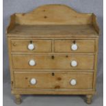 A Victorian pine chest with galleried back and porcelain handles on turned supports. H.97 W.85.5 D.