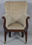 A Regency carved mahogany framed tub armchair in cut floral upholstery raised on square tapering