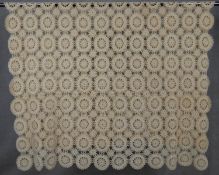 A cream vintage hand crocheted bed throw with stylised repeating floral design. L.218 W.163cm