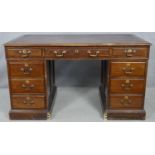 An early 20th century mahogany three section pedestal desk with maker's plaque to the inside and