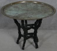 A Benares brass topped occasional table with incised decoration on carved faux bamboo base. H.55 D.