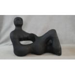 A painted polystyrene sculpture depicting an abstract lying figure. H.88 L.120 W.60cm