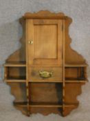 A 19th century beech wall hanging whatnot cabinet fitted with an arrangement of shelves with a