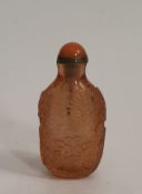 A Chinese carved peach Peking glass snuff bottle, decorated a pair of golden carp for harmony and