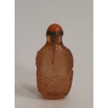A Chinese carved peach Peking glass snuff bottle, decorated a pair of golden carp for harmony and