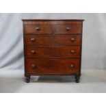 A 19th century mahogany bowfronted chest of drawers with original knob handles and brassware on
