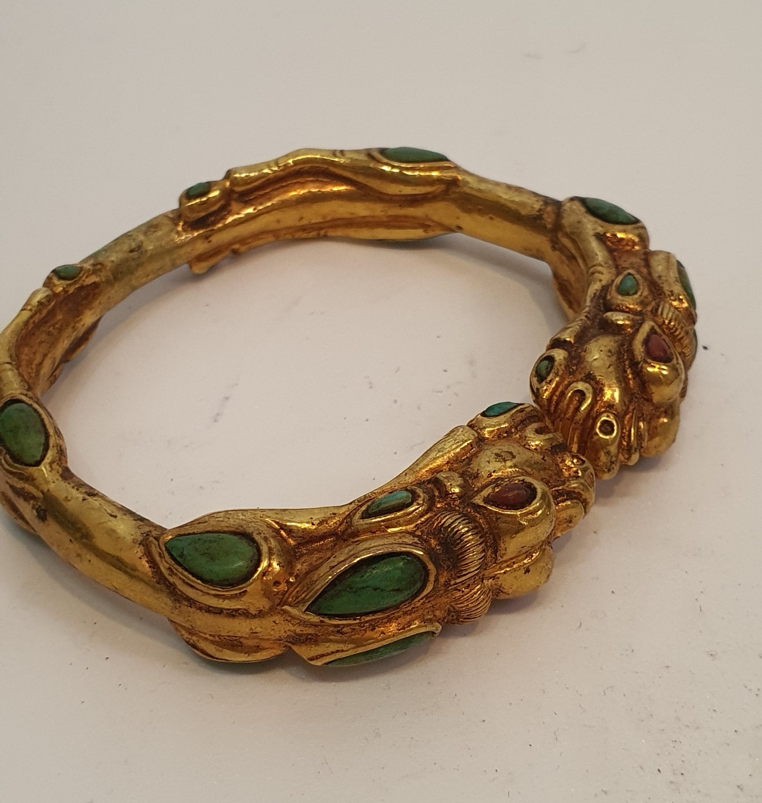 A Tibetan gilded bronze two headed dragon bangle inset with turquoise and red stone cabochons for - Image 4 of 4