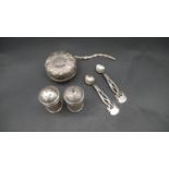 A Goring repousse design silver cased yoyo, Continental silver salt and pepper shakers and a pair of