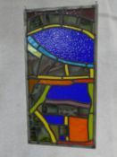 A mid century pane of stained and leaded modern coloured glass with antique and gothic