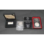 A cased Wonders of the World silver ingot with certificate, a 1983 Olympic US silver dollar proof