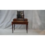 A 19th century walnut dressing table with swing mirror above a pair of frieze drawers on turned