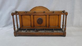 A late 19th century oak Aesthetic style hallstand with arched back and carved monogram and a five