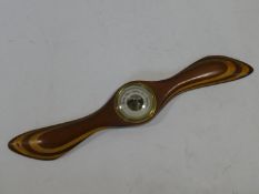 A barometer mounted on a vintage laminated propeller. L.57cm