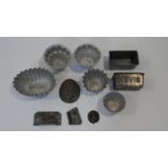 A collection of eleven antique and vintage metal chocolate, bread and jelly moulds. Including a