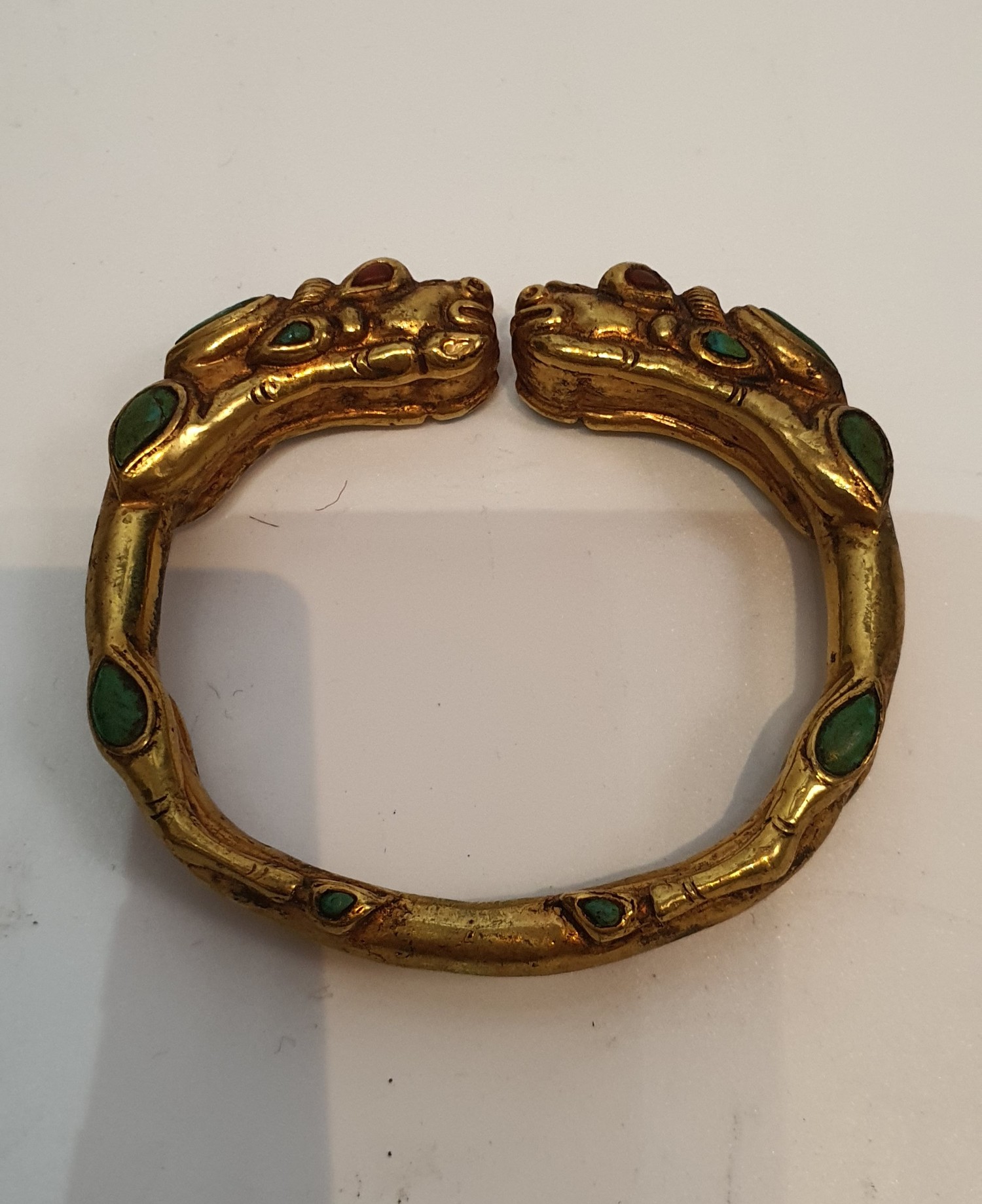 A Tibetan gilded bronze two headed dragon bangle inset with turquoise and red stone cabochons for - Image 2 of 4