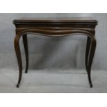 An antique mahogany Louis XV style fold over top card table with tooled leather inset top and pull