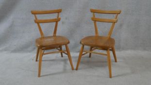 A pair of mid century vintage Ercol light elm and beech red dot child's chairs. H.59cm