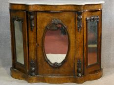 A Victorian burr walnut marble topped credenza with bowed and shaped top above carved and mirrored