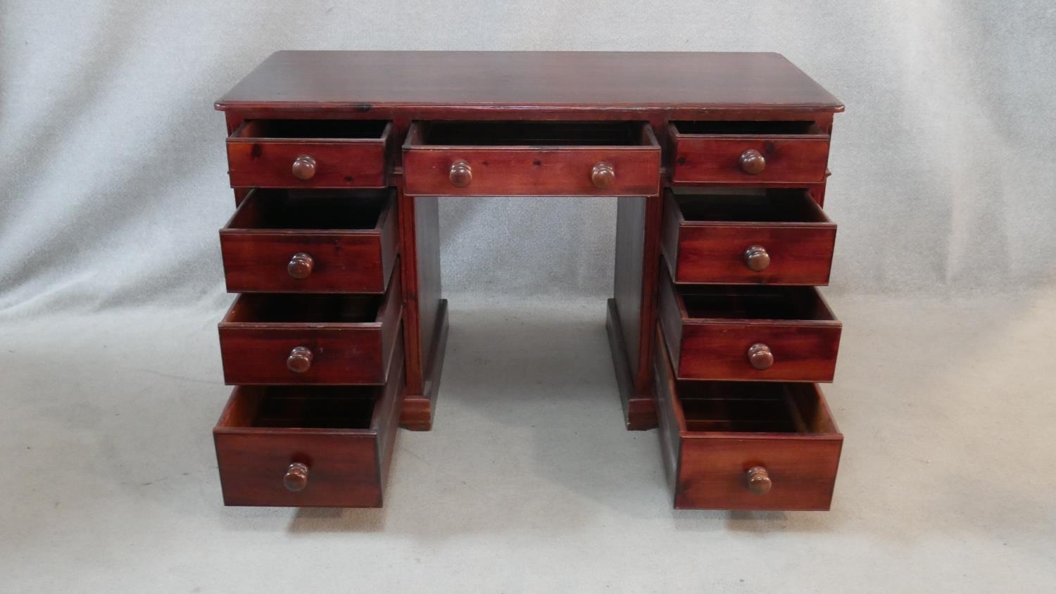 A Victorian style stained pine pedestal desk with an arrangement of nine drawers on shaped plinth - Image 2 of 5