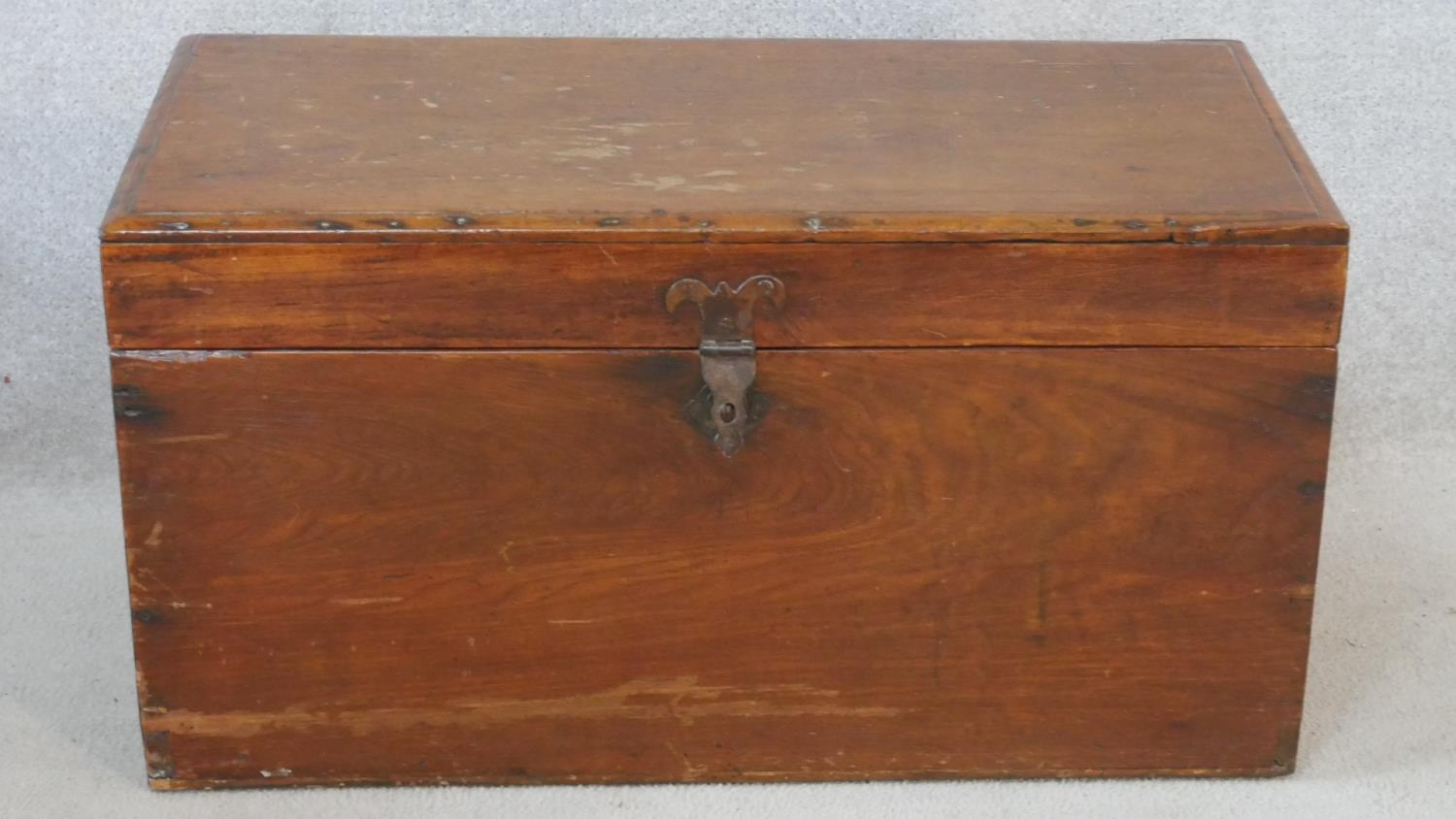 A 19th century camphor hinged lidded travelling trunk with twin iron carrying handles. H.40 W.77 D.