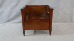 A 19th century Continental mahogany commode with lift up seat on turned supports. H.70 W.76 D.59cm