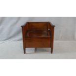 A 19th century Continental mahogany commode with lift up seat on turned supports. H.70 W.76 D.59cm