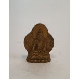 A Tibetan gilded bronze buddha with ray of light behind. H.7cm