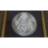 A composite marble relief plaque in gilt frame, three cherubs. H.44 W.44cm