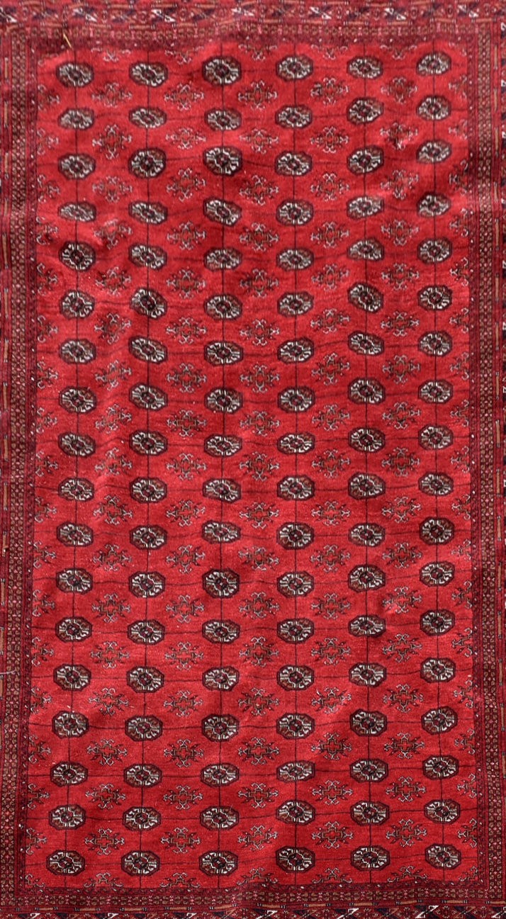 An Afghan Bokhara carpet with repeating gul motifs across the madder field enclosed by geometric - Image 2 of 4