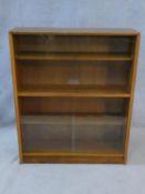 A mid century vintage teak bookcase with two pairs of glass sliding doors. H.92 W.112 D.24cm