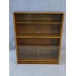 A mid century vintage teak bookcase with two pairs of glass sliding doors. H.92 W.112 D.24cm