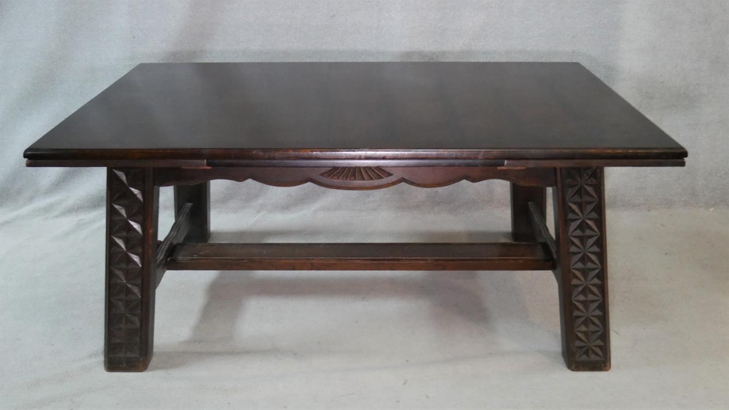 A vintage oak draw leaf dining table on carved square stretchered and pegged supports. H.76 L.267