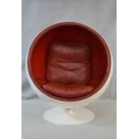 After Eero Aarnio, a vintage white polyester Ball Chair on swivel metal base with burgundy leather