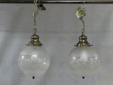 A pair of etched and frosted glass ceiling light pendants of globular shape. H.42 D.50cm